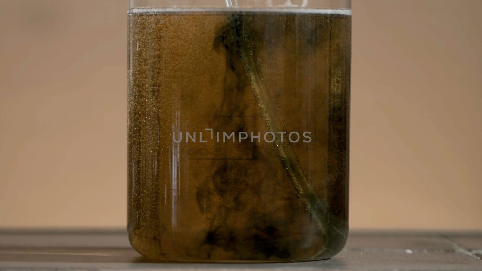 Test tube close up. Black liquid in the flask. The liquid in the flask changes color photo