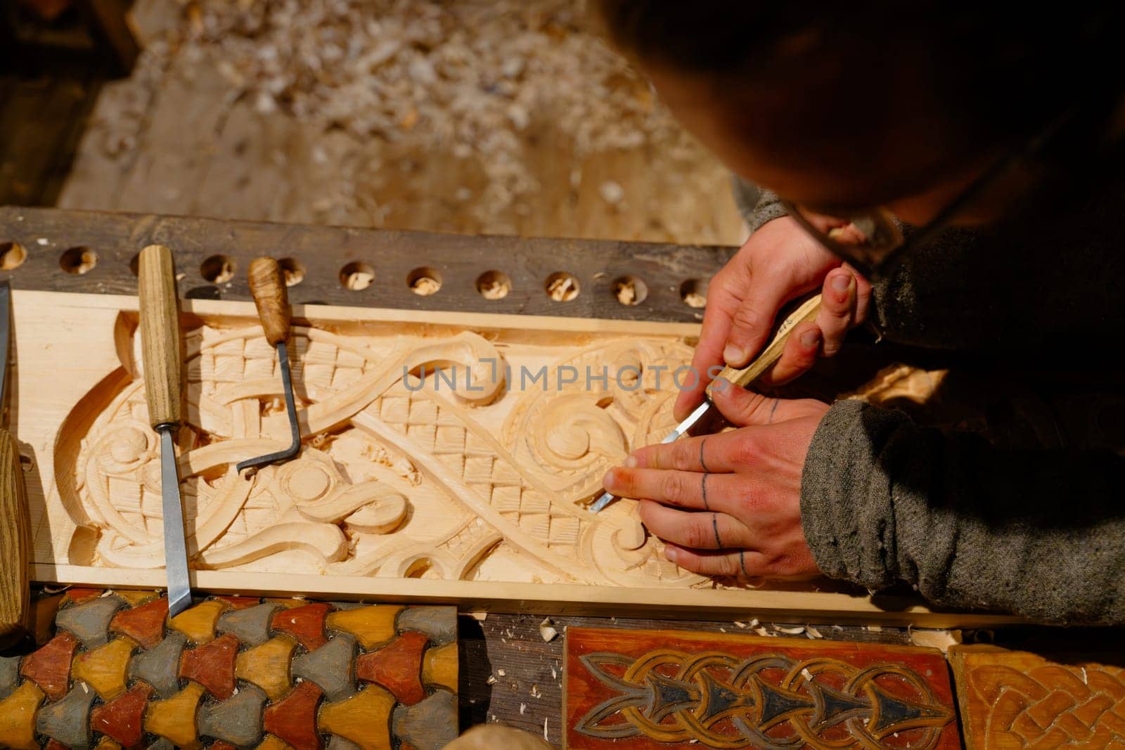 Skilled Carpenter Carving Intricate Designs on Wood for Artisanal Creations by PhotoTime