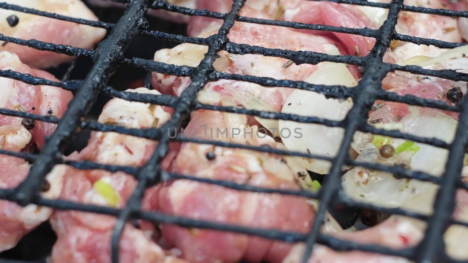 Close-up of cooking meat on grill. Concept. Juicy meat is cooked on grill in nature. Delicious meat is grilled on grill in nature.