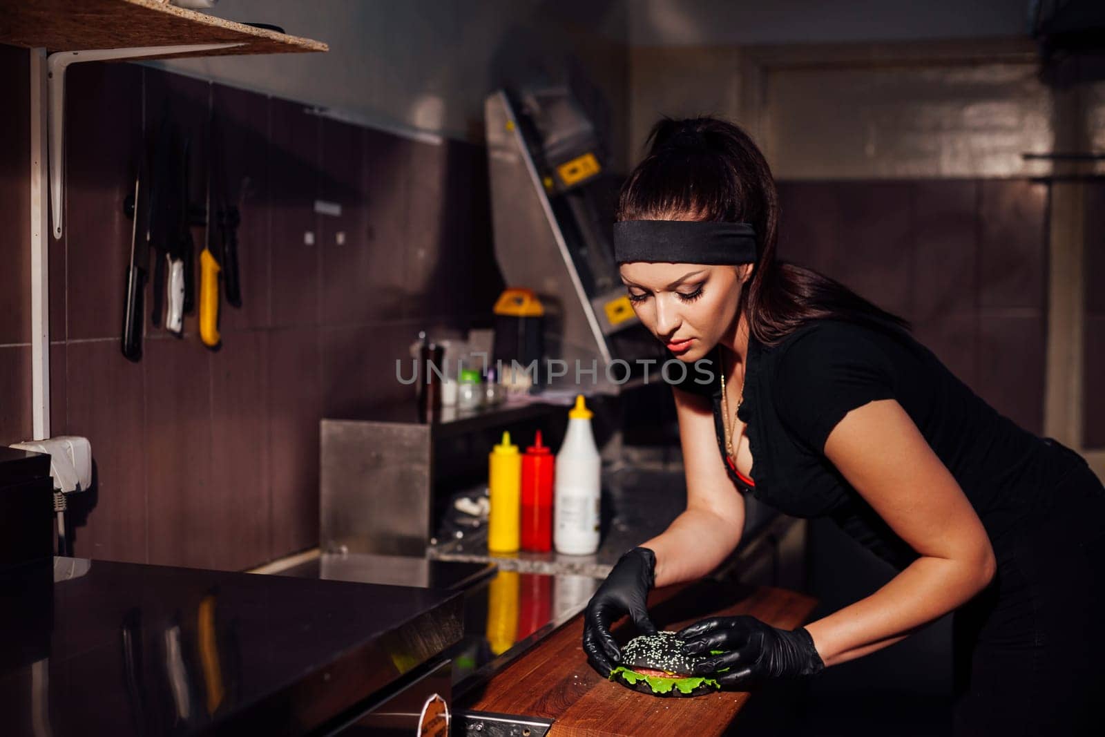 beautiful girl Cook prepares the kitchen Burger 1