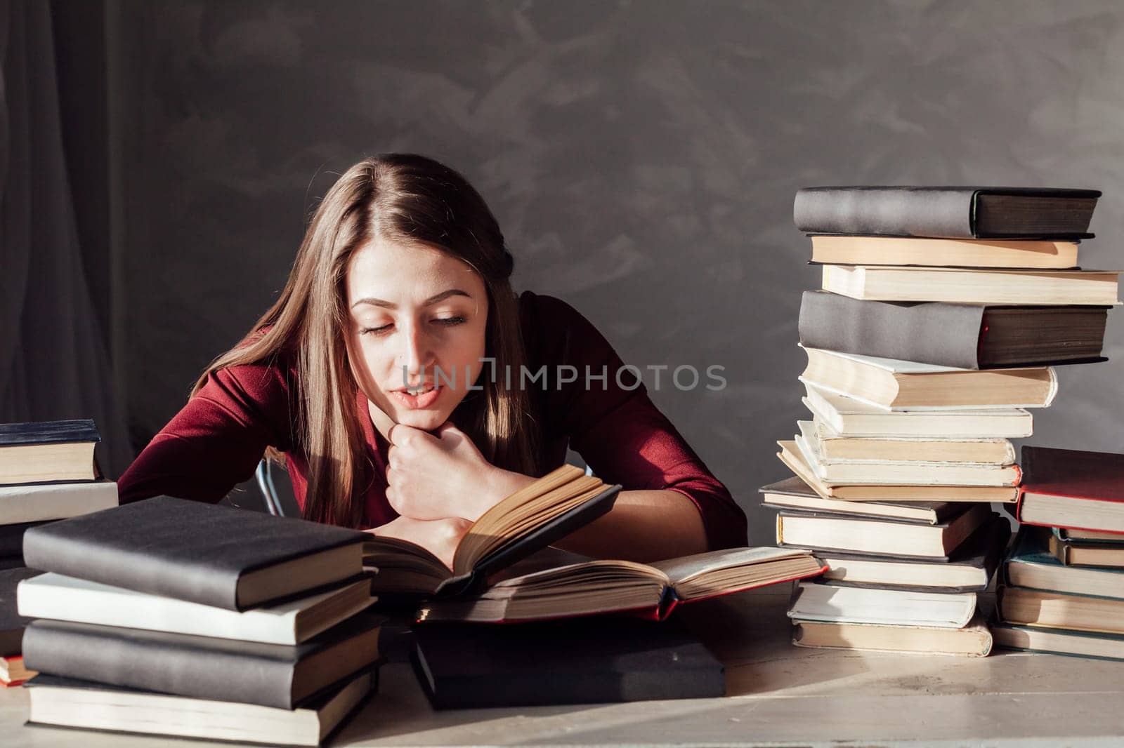 girl reading book prepares for the exam in the library 2