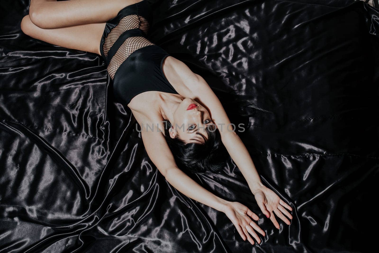 sexy girl in black underwear lies on the silk bed bed 1