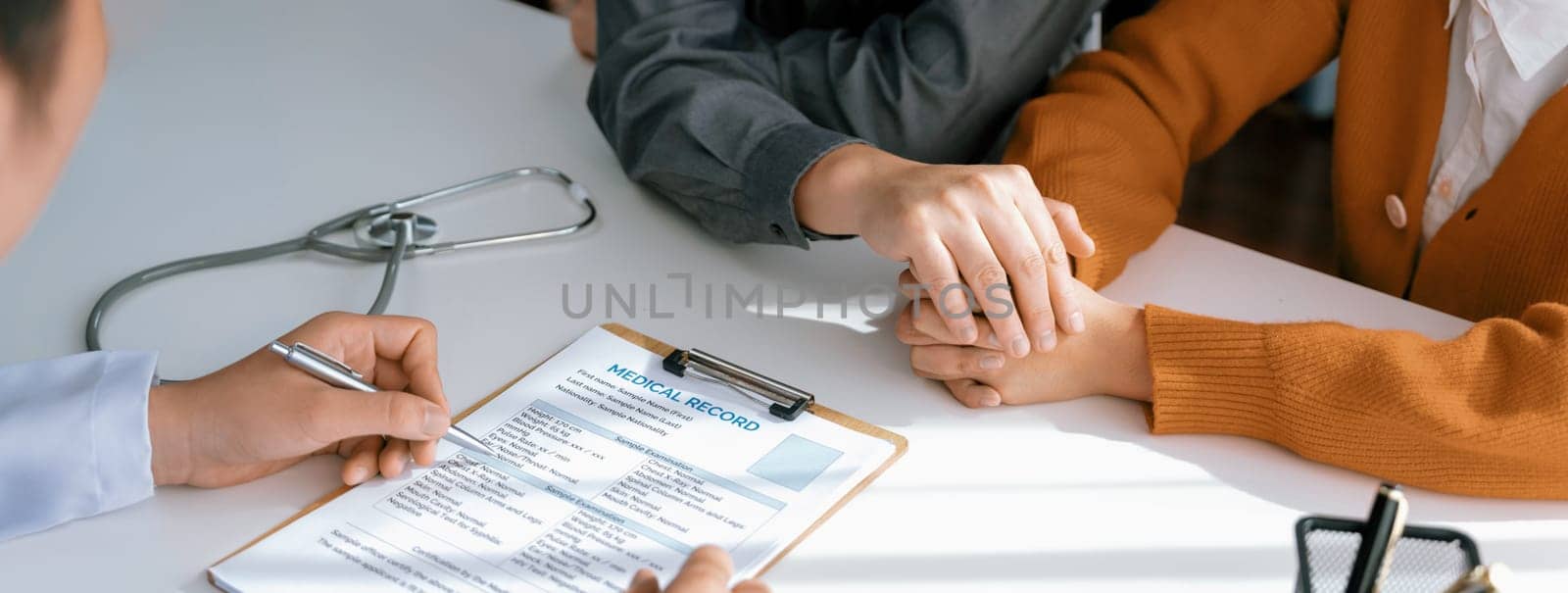 Couple attend fertility or medical consultation with gynecologist at hospital as family planning care for pregnancy. Husband and wife consoling each other through doctor appointment. Panorama Rigid