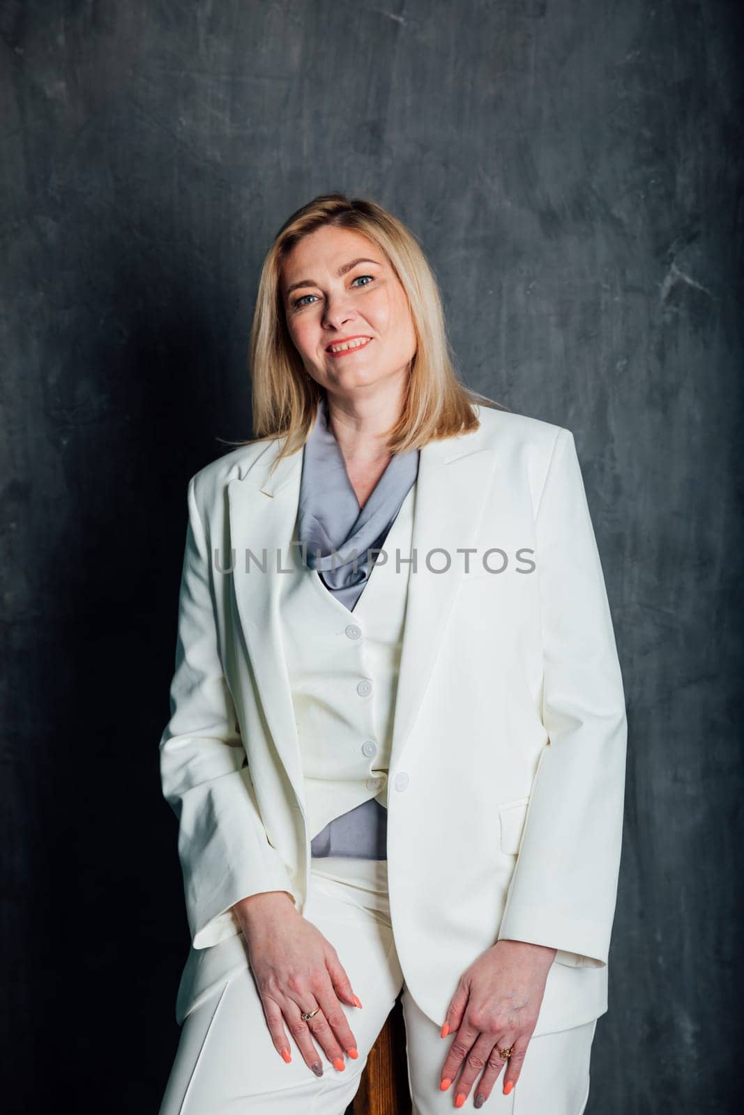 Adult woman in white business suit by Simakov