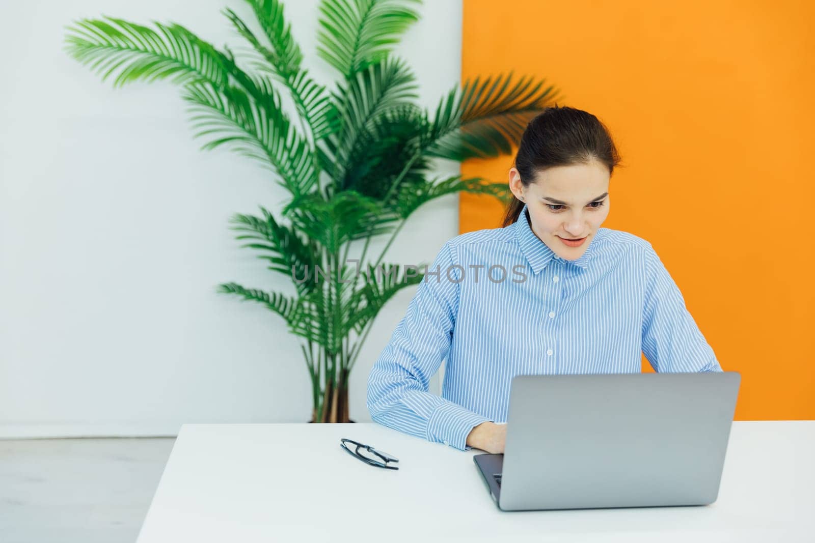 Woman on laptop online financial business from office by Simakov