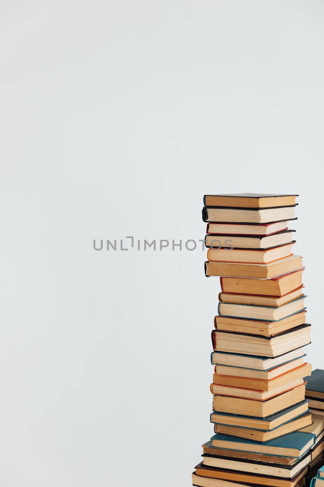 Stacks of books in university library on white background