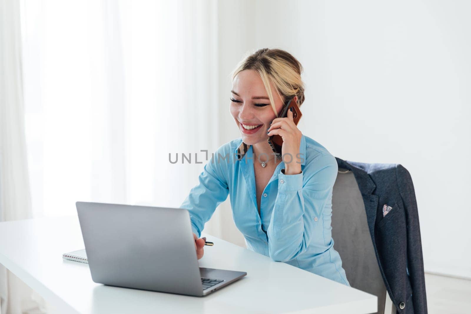 woman conducting financial negotiations online on phone and laptop