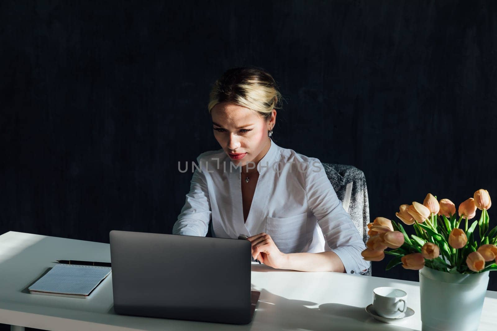 woman working on laptop in office online