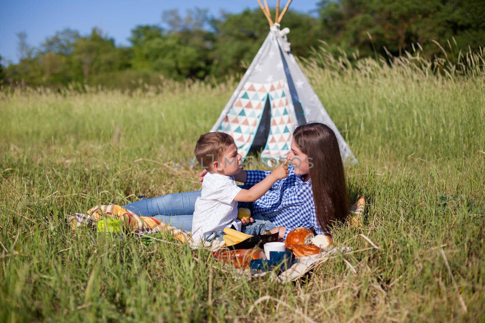 mom with her son on a picnic rest in nature