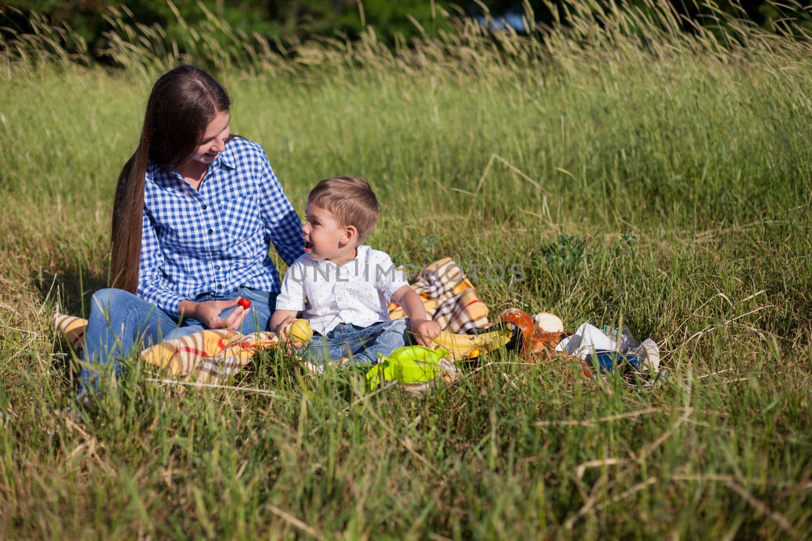 mom with her son on a picnic rest in nature