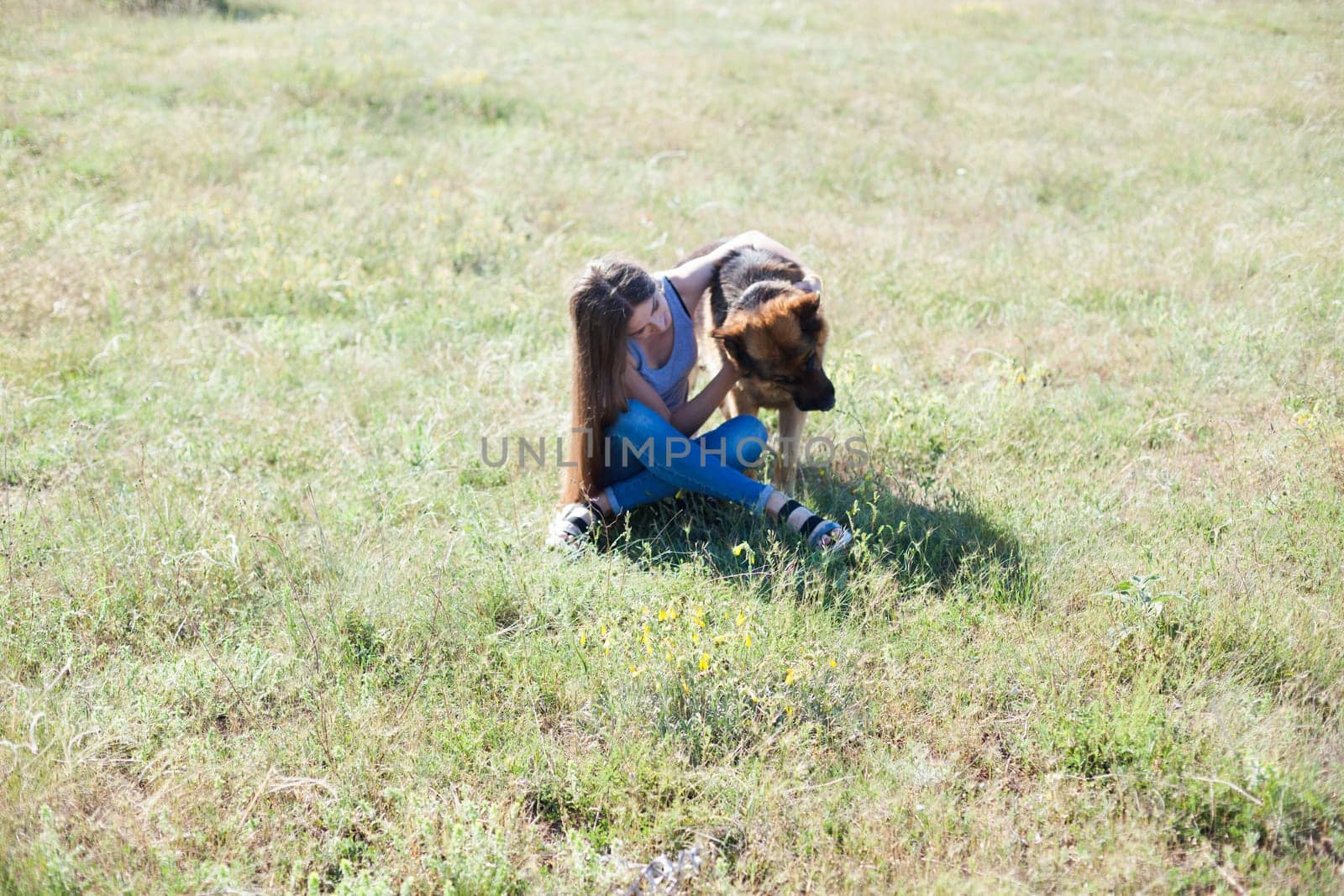 Woman on a walk with German Shepherd dog by Simakov