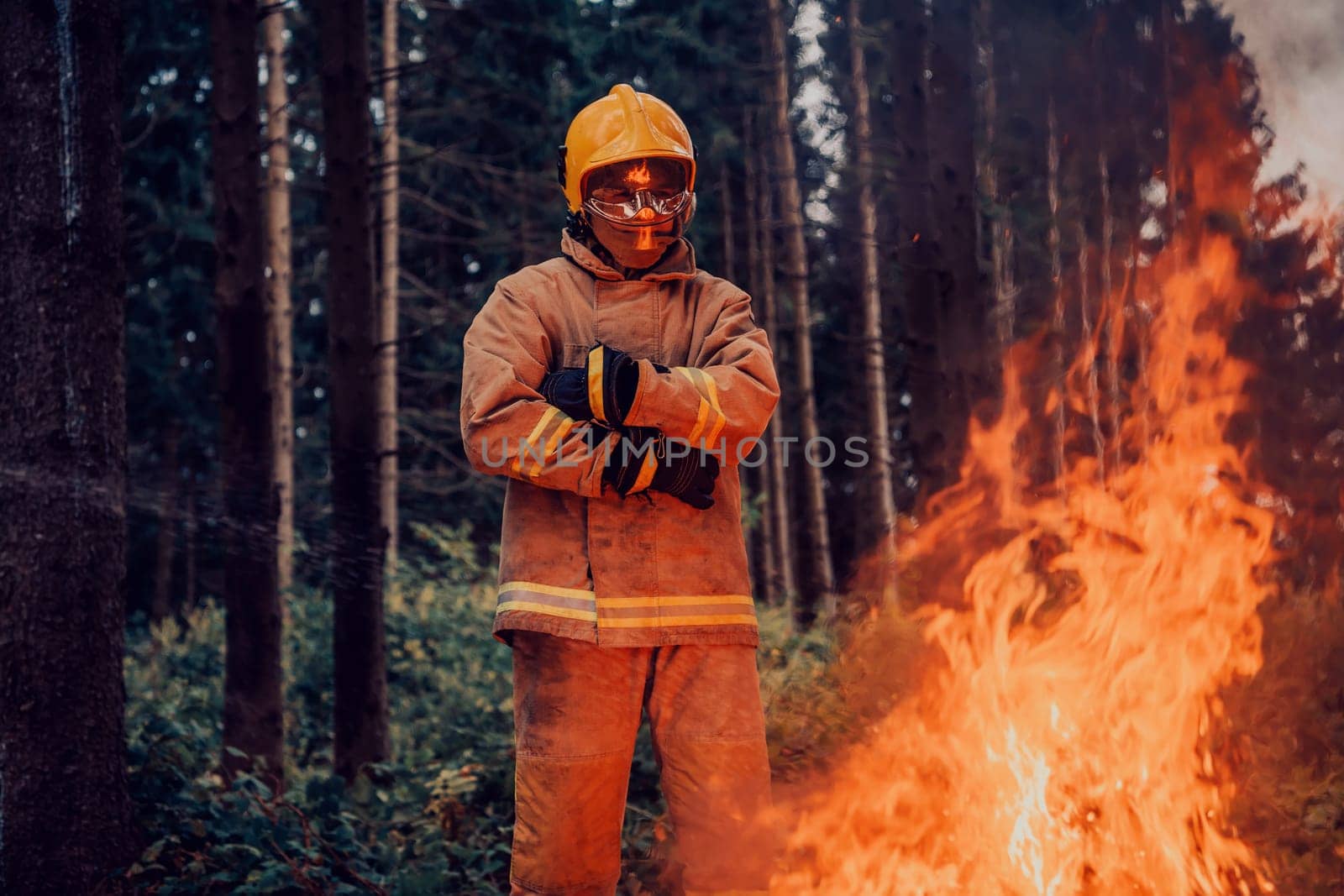 Firefighter at job. Firefighter in dangerous forest areas surrounded by strong fire. Concept of the work of the fire service by dotshock