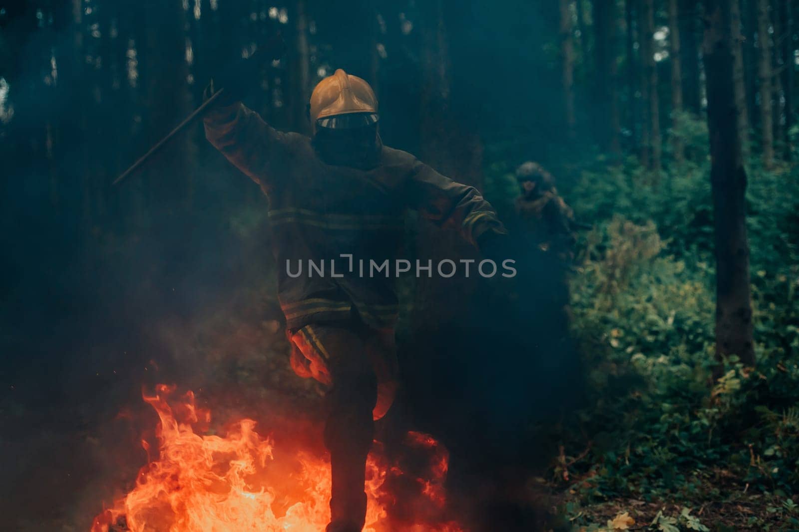 firefighter hero in action danger jumping over fire flame to rescue and save.