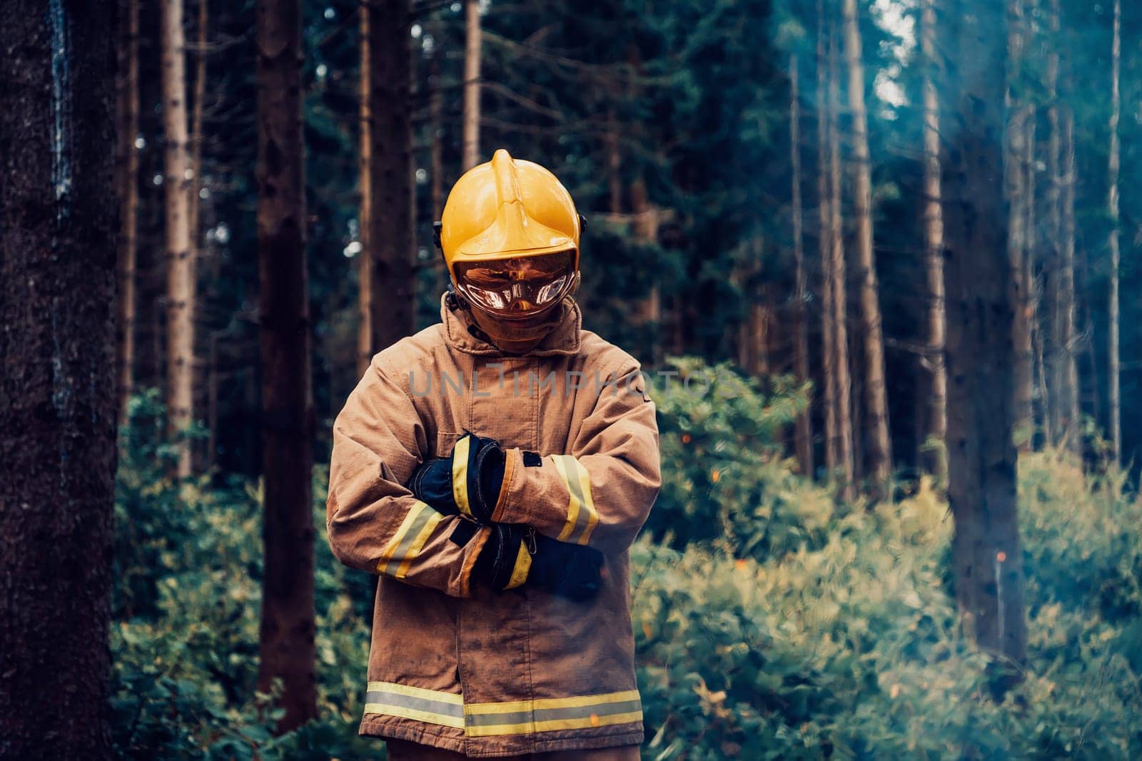 Firefighter at job. Firefighter in dangerous forest areas surrounded by strong fire. Concept of the work of the fire service. H