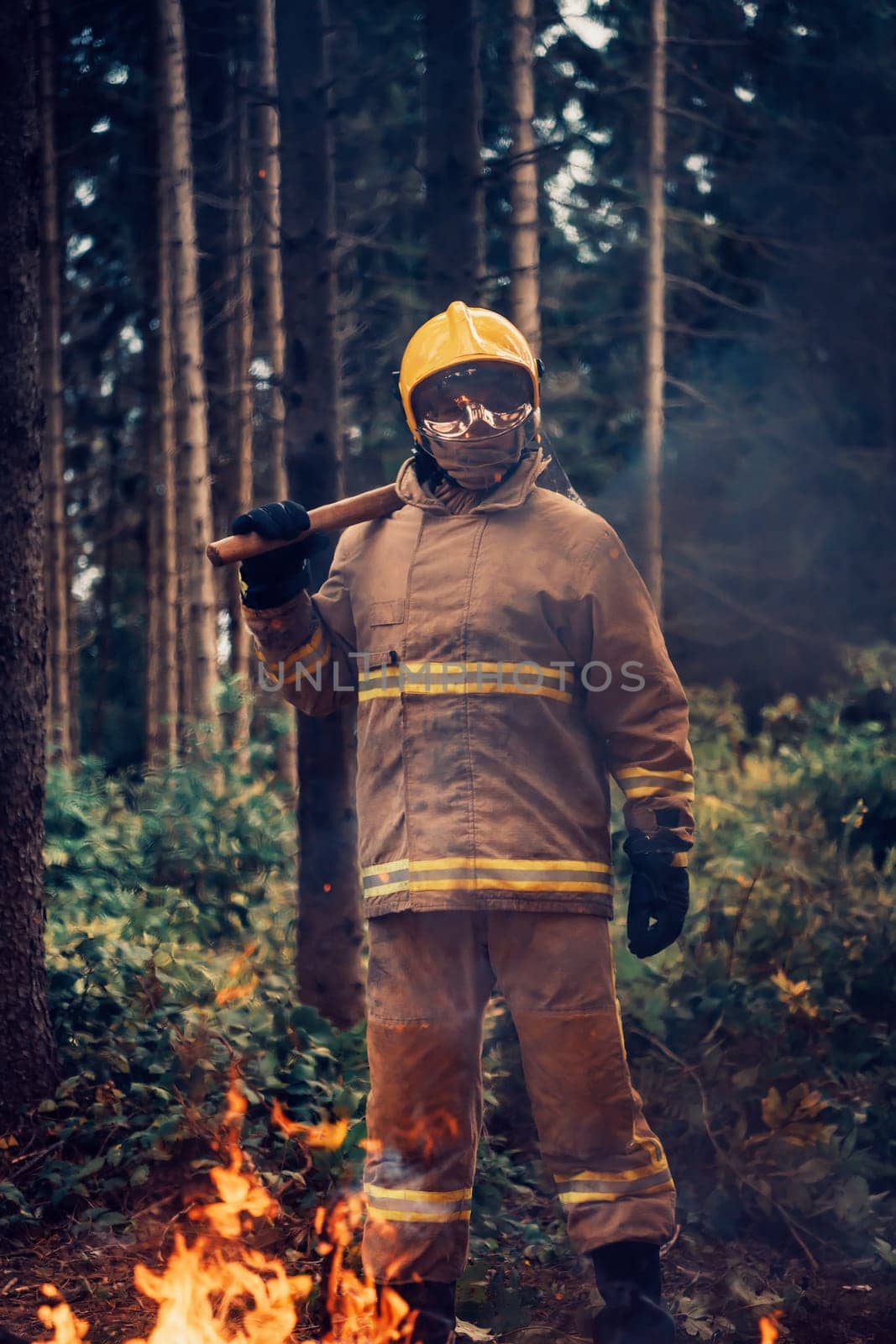 Firefighter at job. Firefighter in dangerous forest areas surrounded by strong fire. Concept of the work of the fire service. H