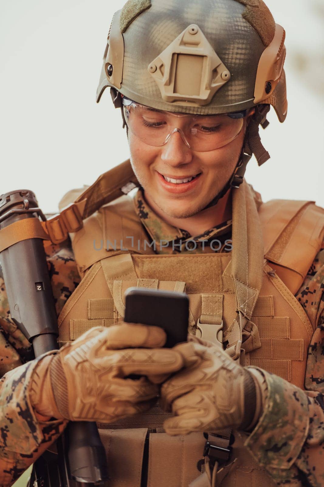 Soldier using smartphone to contact family or girlfriend communication and nostalgia concept.