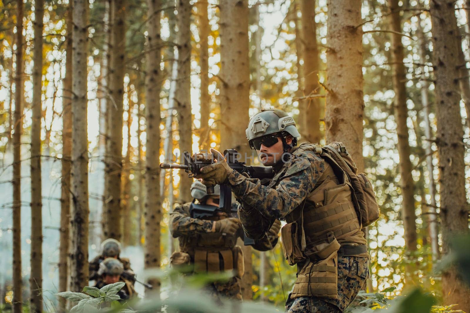 A group of modern warfare soldiers is fighting a war in dangerous remote forest areas. A group of soldiers is fighting on the enemy line with modern weapons. The concept of warfare and military conflicts.