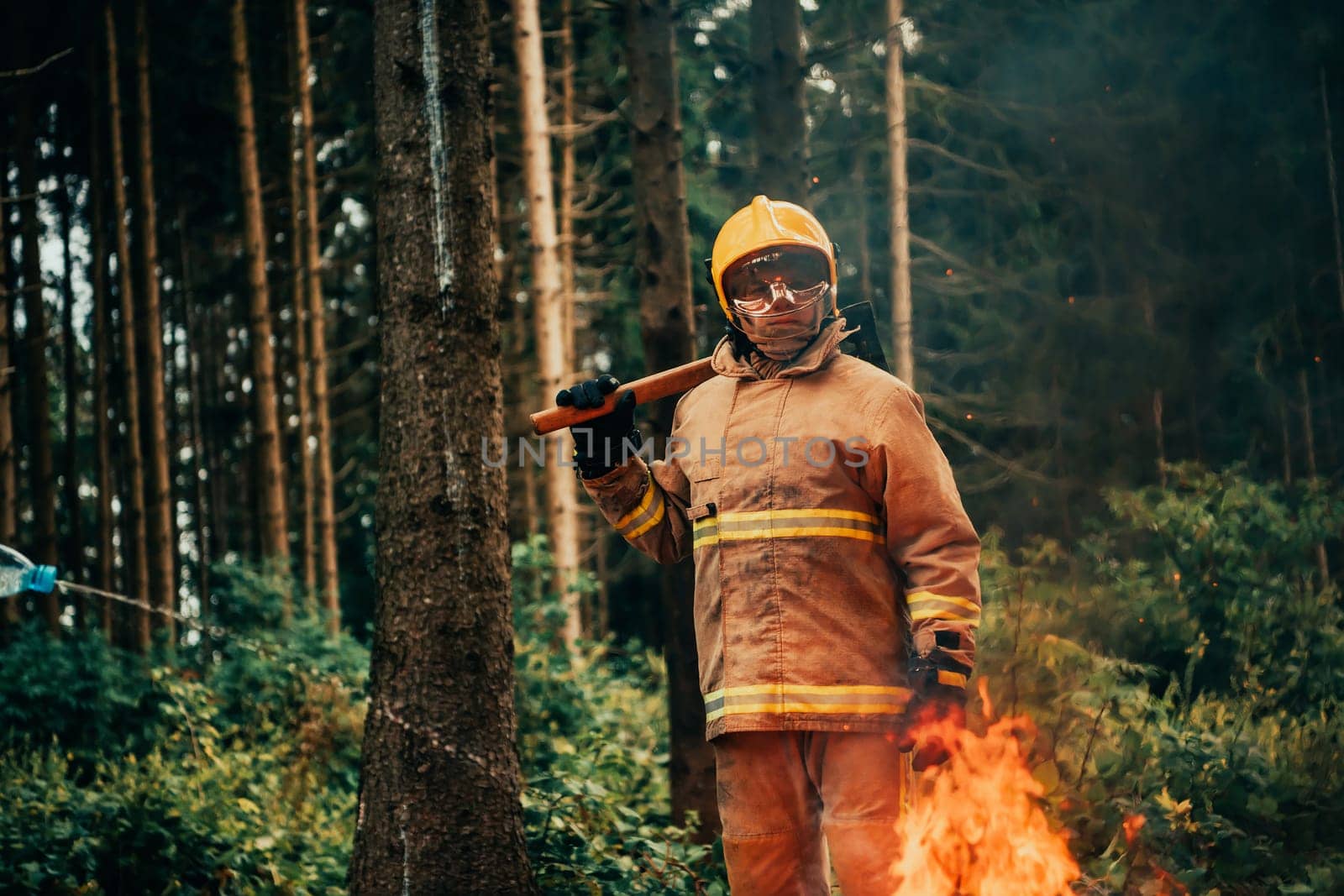 Firefighter at job. Firefighter in dangerous forest areas surrounded by strong fire. Concept of the work of the fire service. H