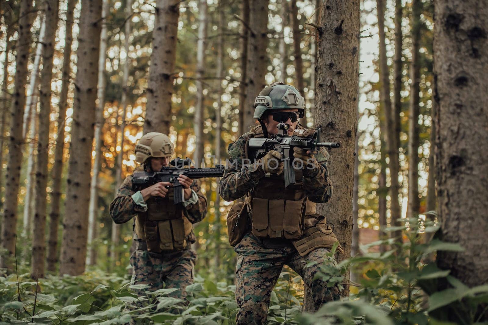 A group of modern warfare soldiers is fighting a war in dangerous remote forest areas. A group of soldiers is fighting on the enemy line with modern weapons. The concept of warfare and military conflicts by dotshock
