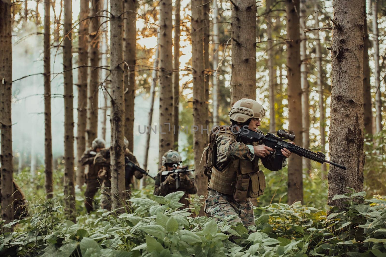 A group of modern warfare soldiers is fighting a war in dangerous remote forest areas. A group of soldiers is fighting on the enemy line with modern weapons. The concept of warfare and military conflicts by dotshock