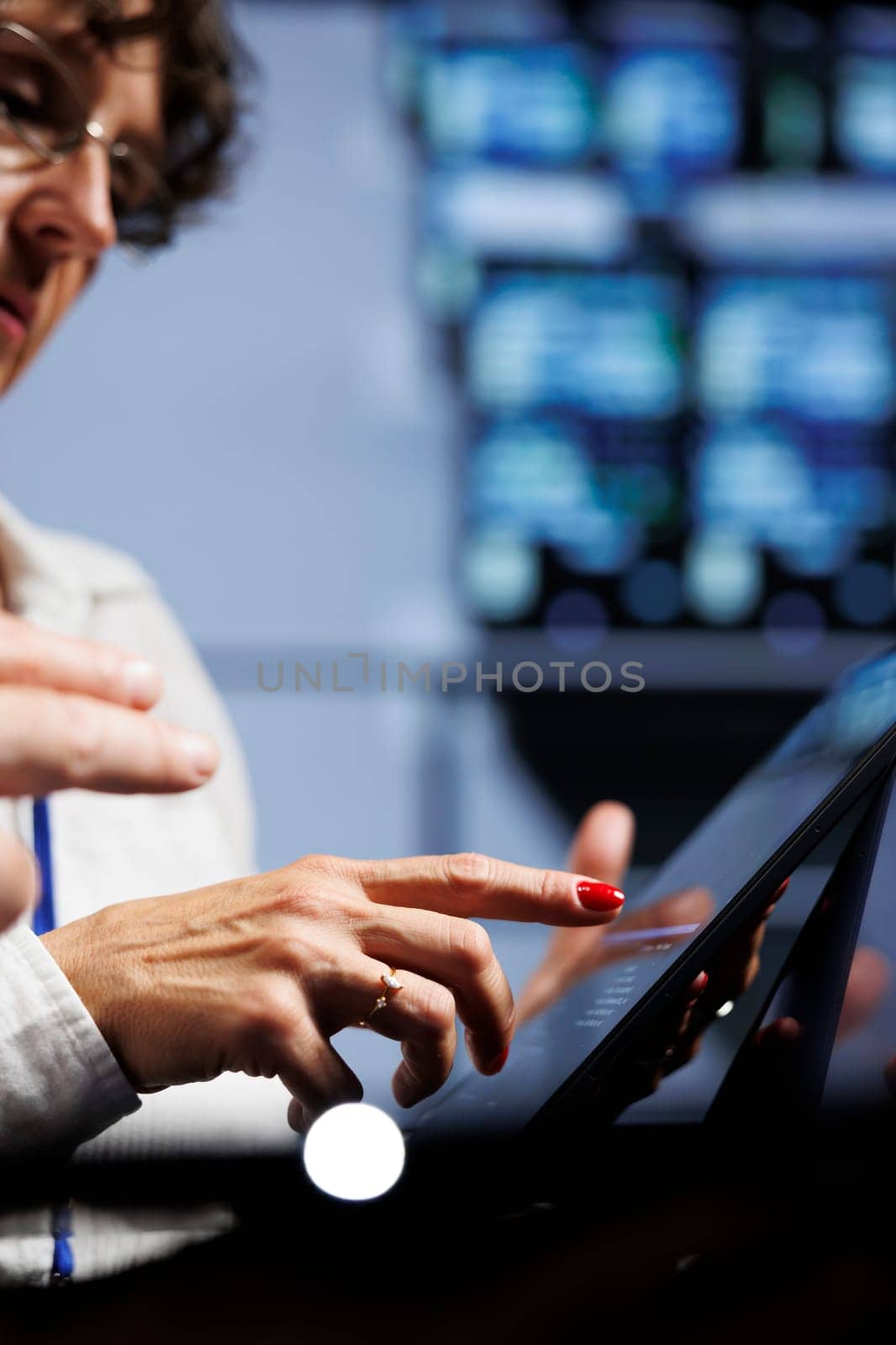 Trained technicians updating data center hardware, writing intricate binary code scripts on tablet, using programming to fortify cybersecurity in server room, close up