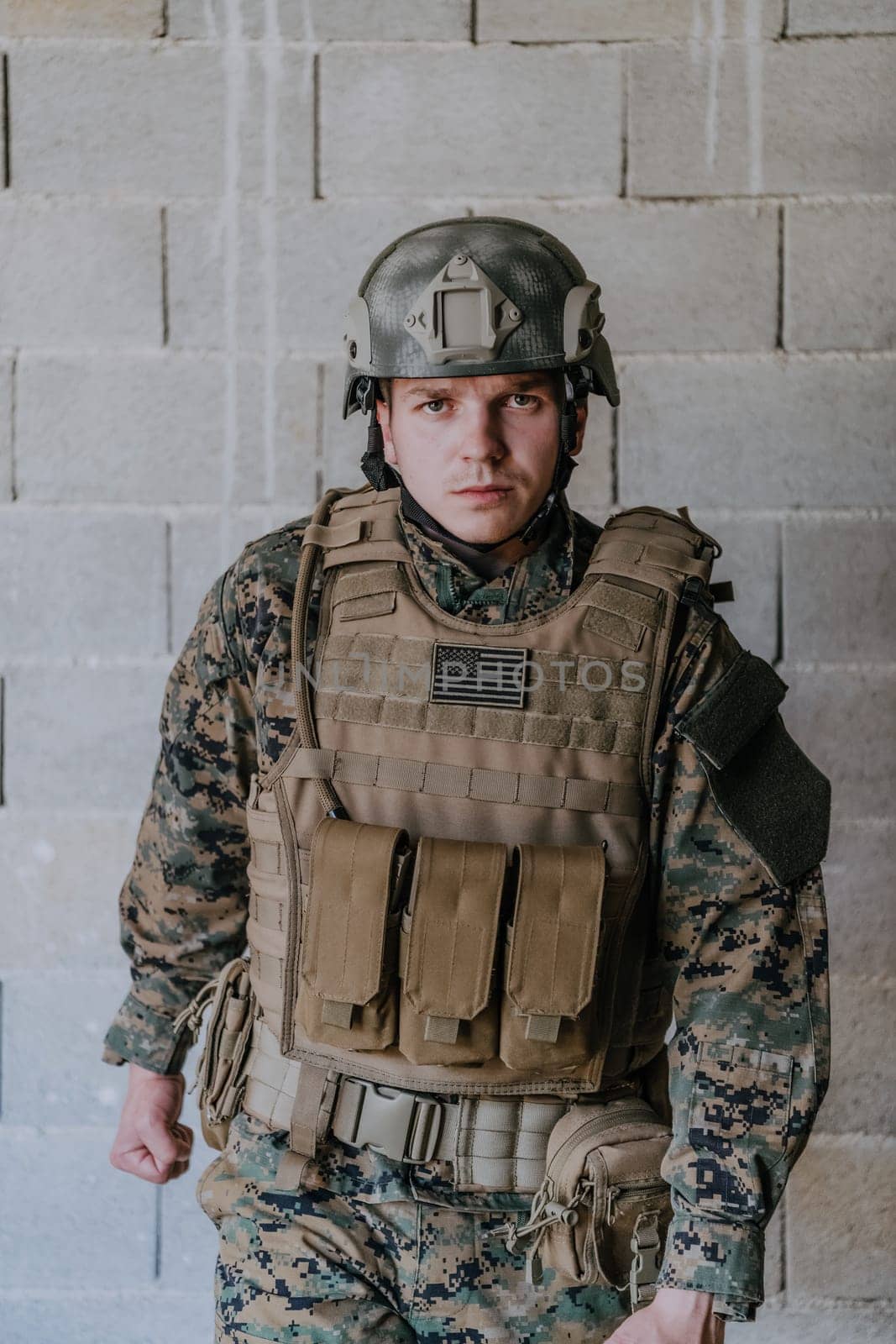 Soldier preparing tactical protective and communication gear for action battle.