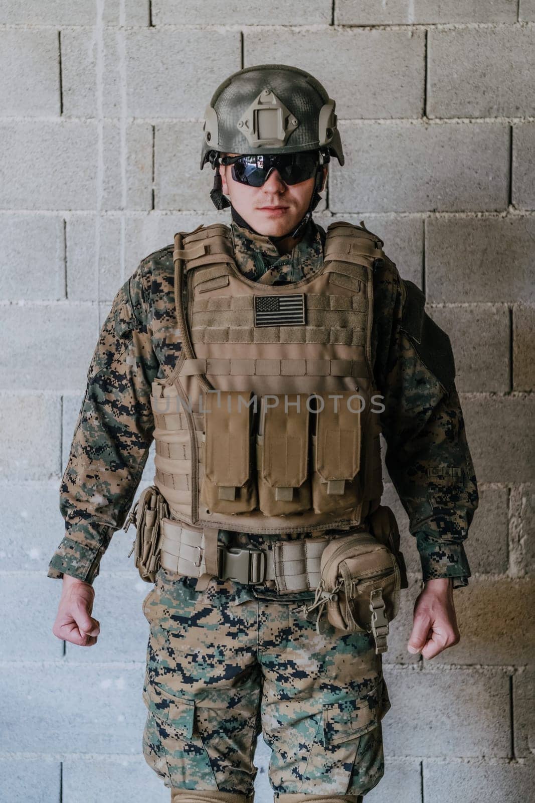 Soldier preparing tactical protective and communication gear for action battle.