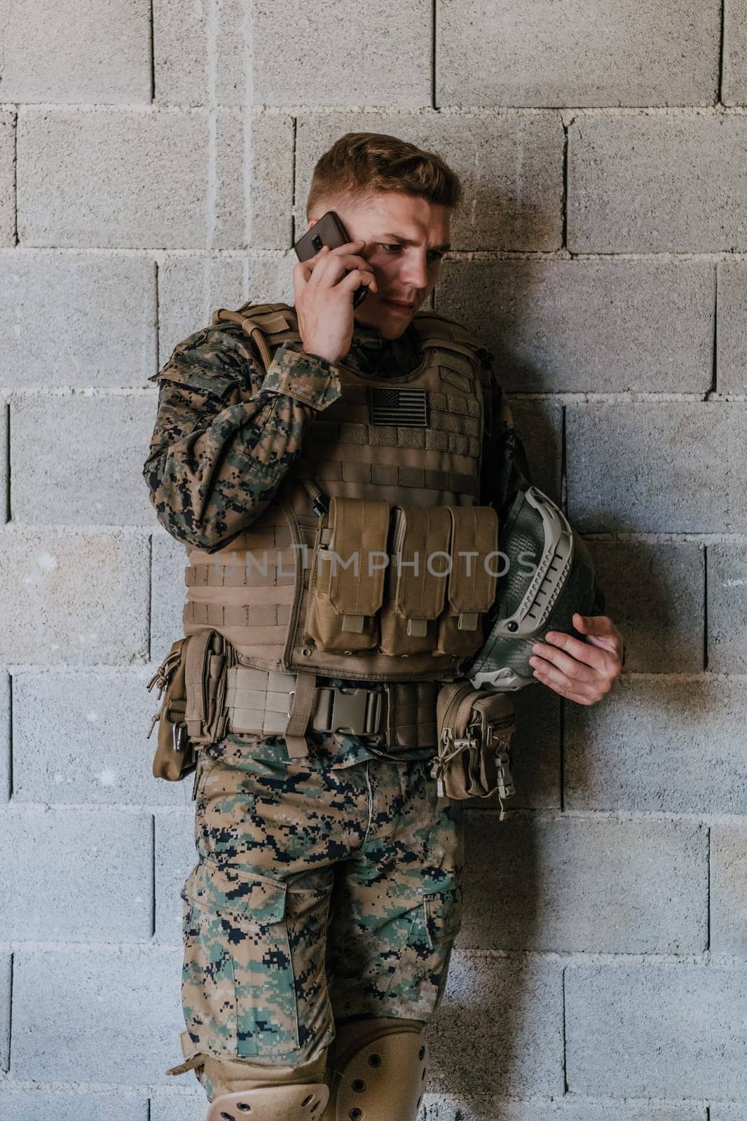 Soldier using smartphone and calling home family and frinds.