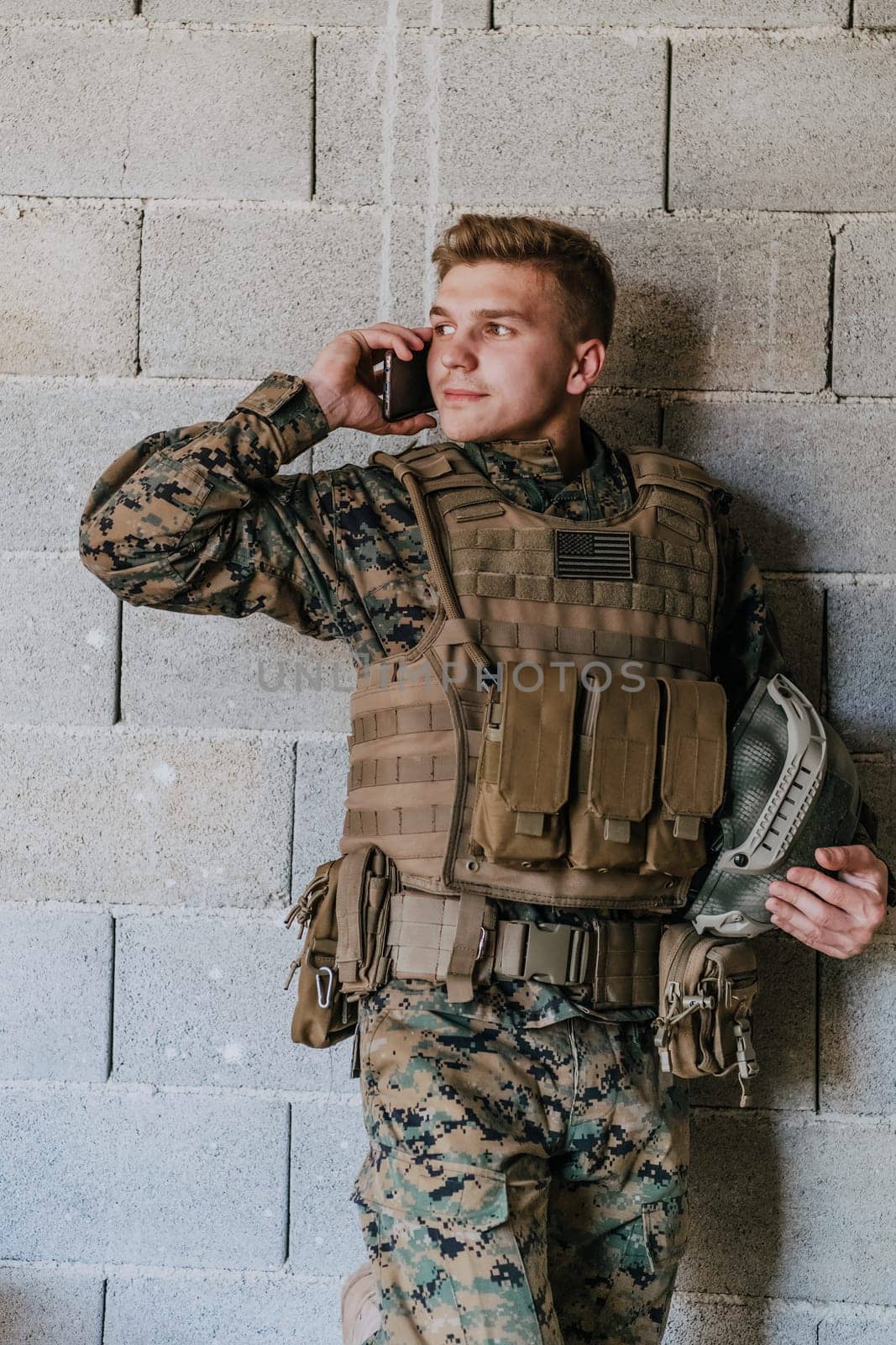 Soldier using smartphone and calling home family and frinds.