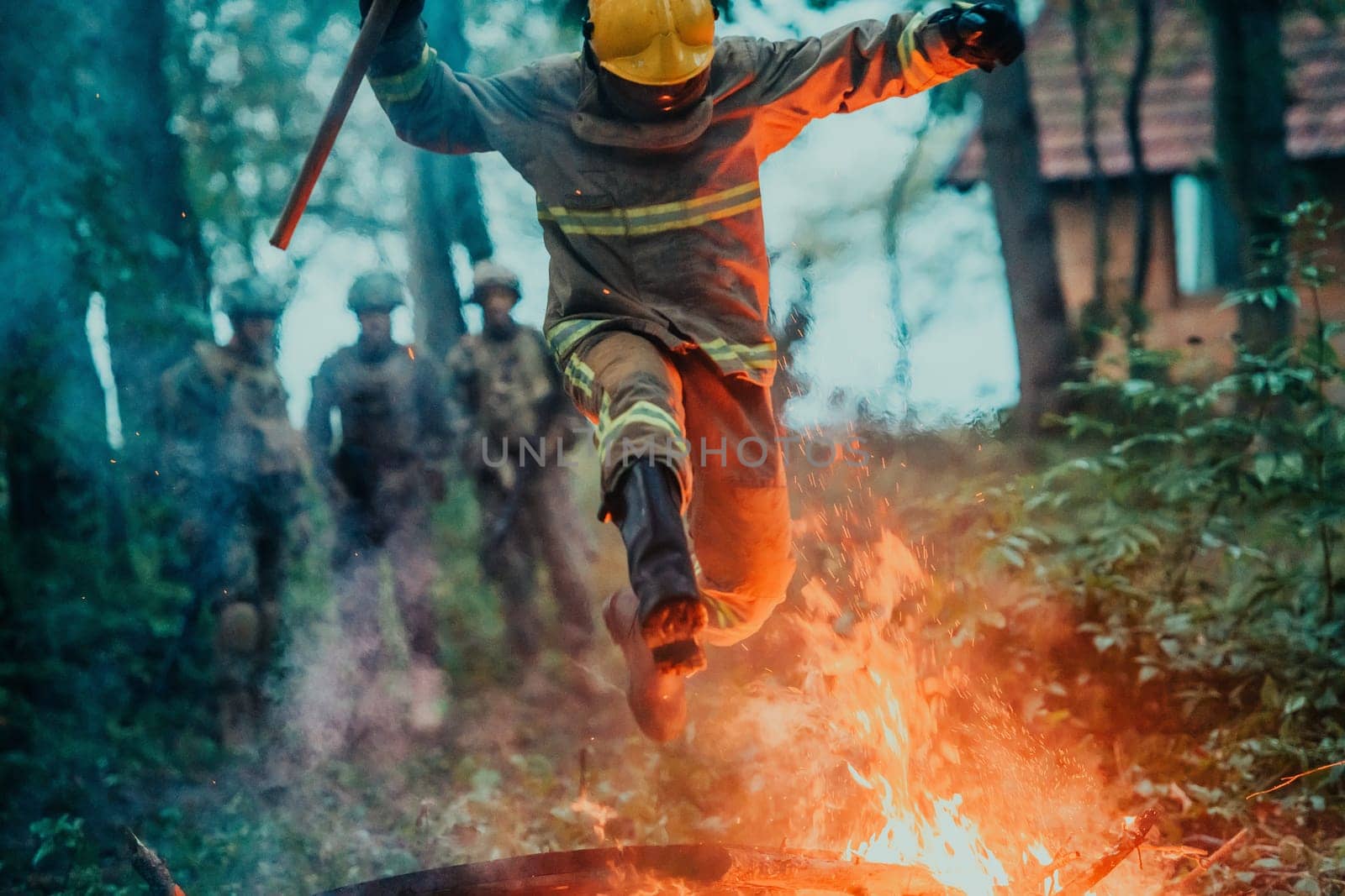 firefighter hero in action danger jumping over fire flame to rescue and save.