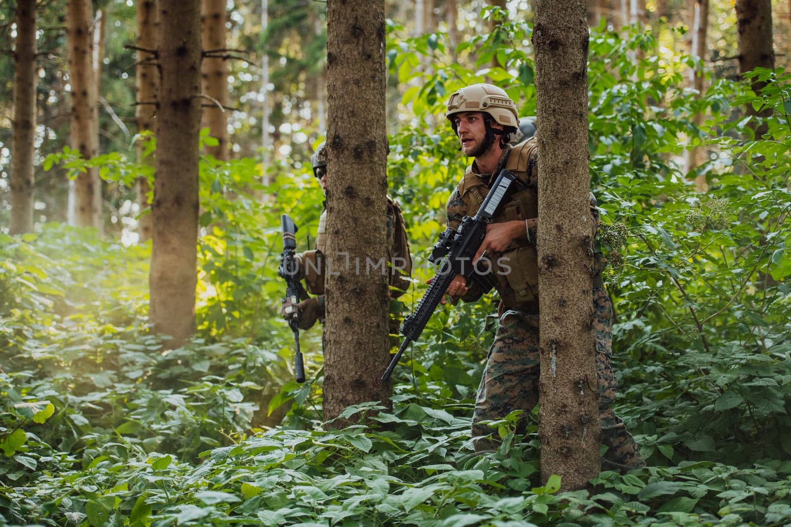 A group of modern warfare soldiers is fighting a war in dangerous remote forest areas. A group of soldiers is fighting on the enemy line with modern weapons. The concept of warfare and military conflicts by dotshock