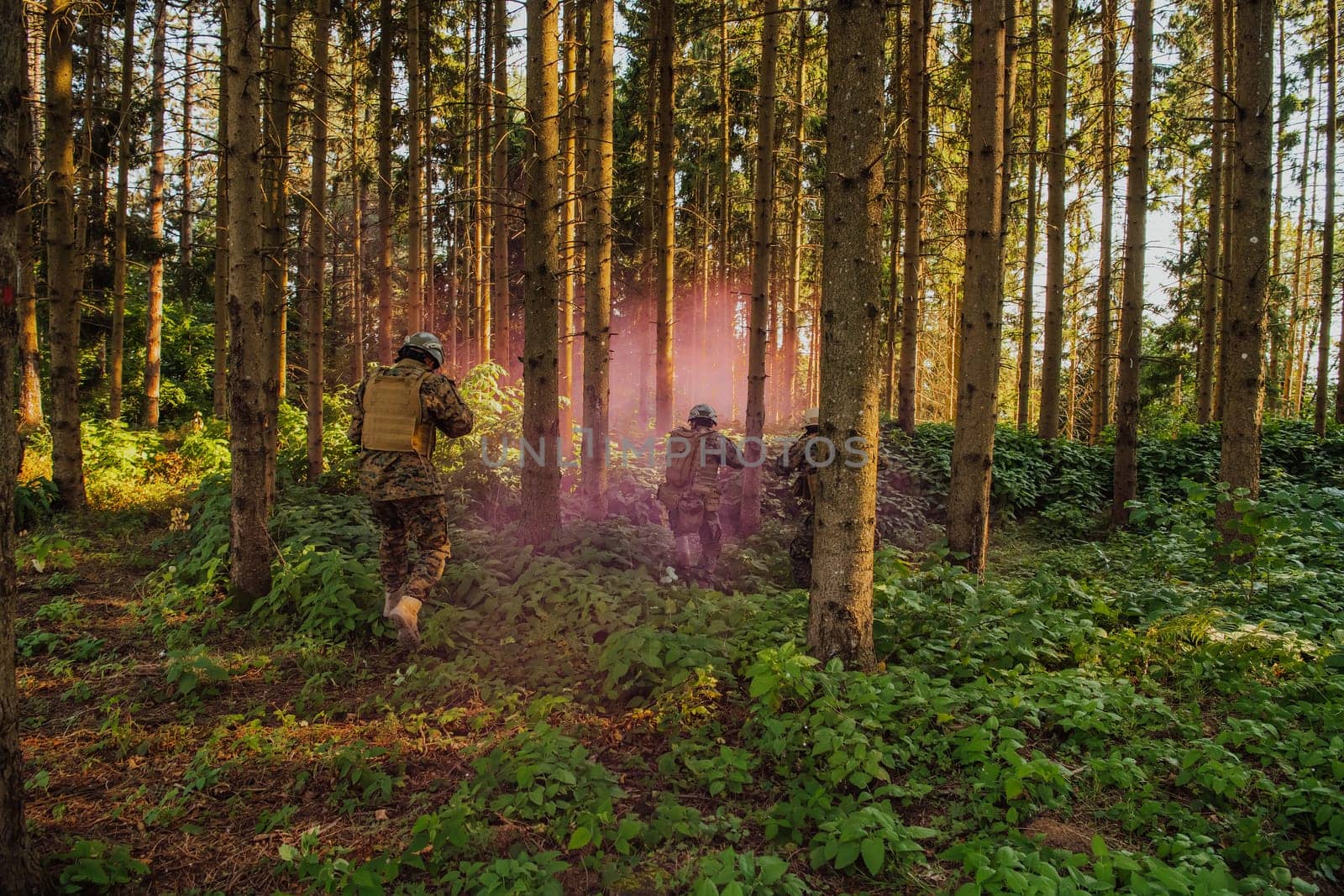 A group of modern warfare soldiers is fighting a war in dangerous remote forest areas. A group of soldiers is fighting on the enemy line with modern weapons. The concept of warfare and military conflicts by dotshock