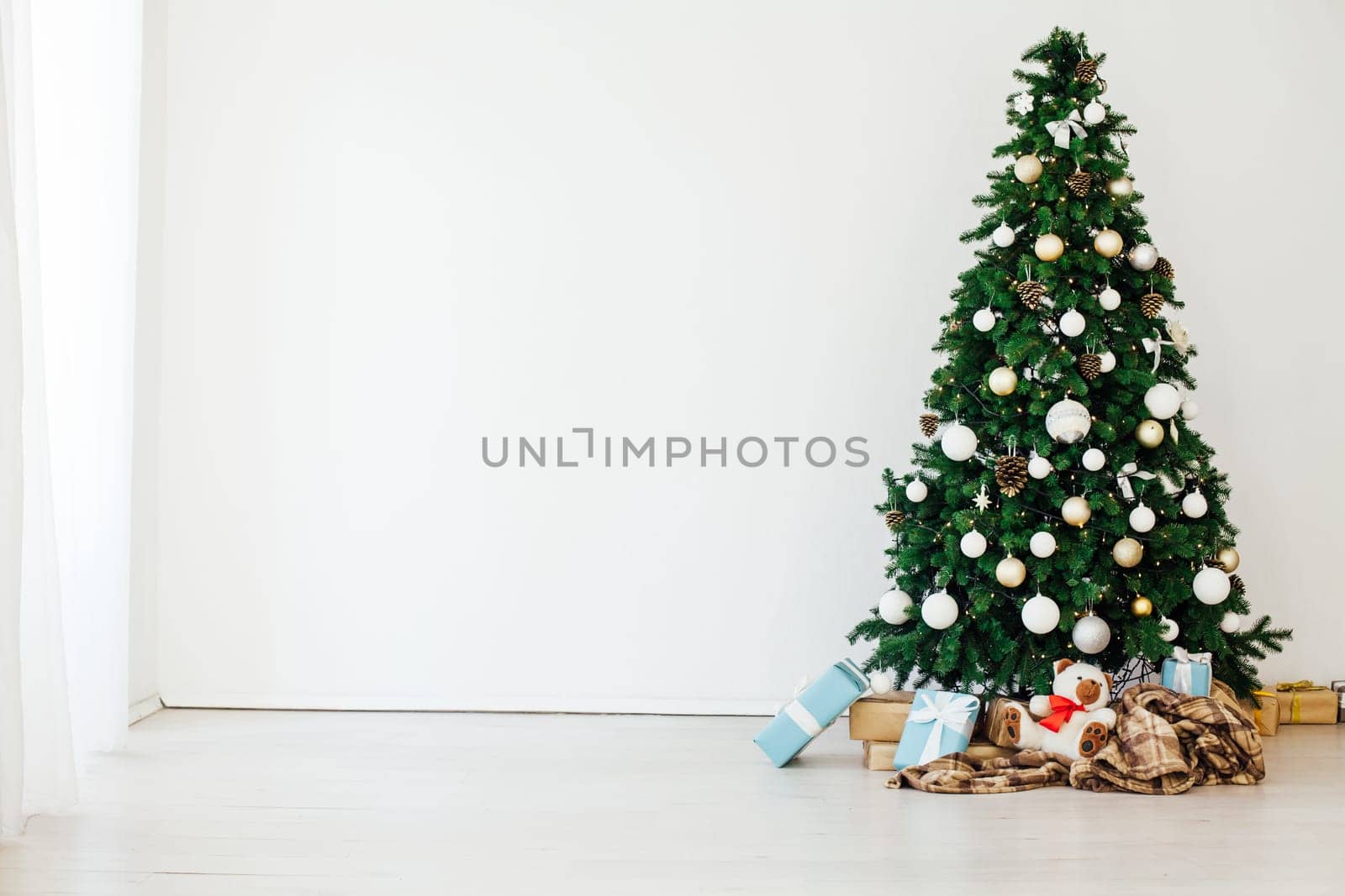 Christmas tree with gifts in the new year decor winter interior by Simakov