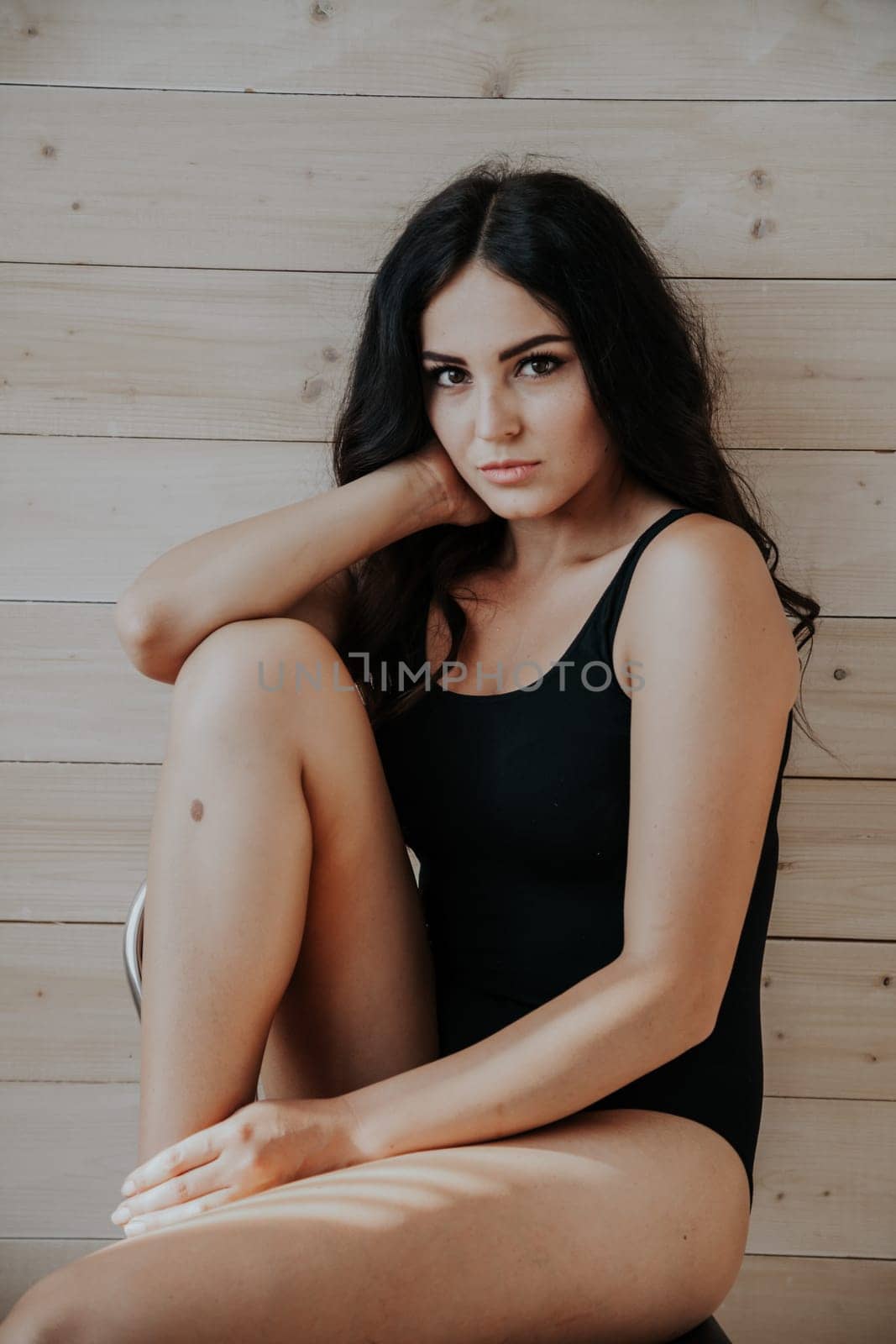 nice girl in black body posing in the Studio by Simakov