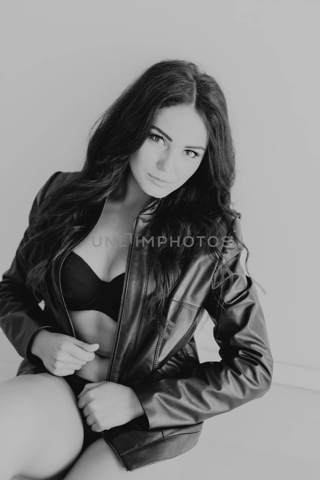 brunette girl in leather jacket and black lingerie by Simakov