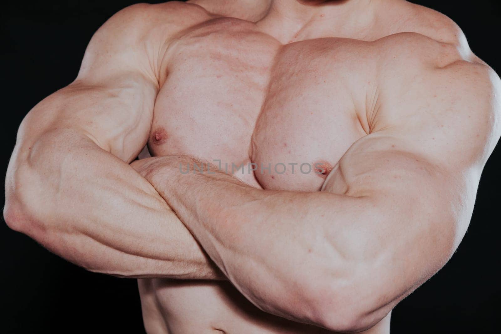 Sport the athlete bodybuilder shows off his muscles 2