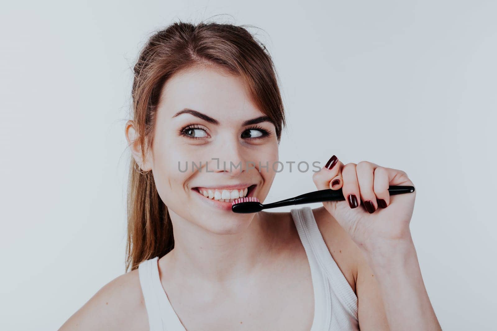 pretty girl in the bathroom brushing his teeth smile dentistry