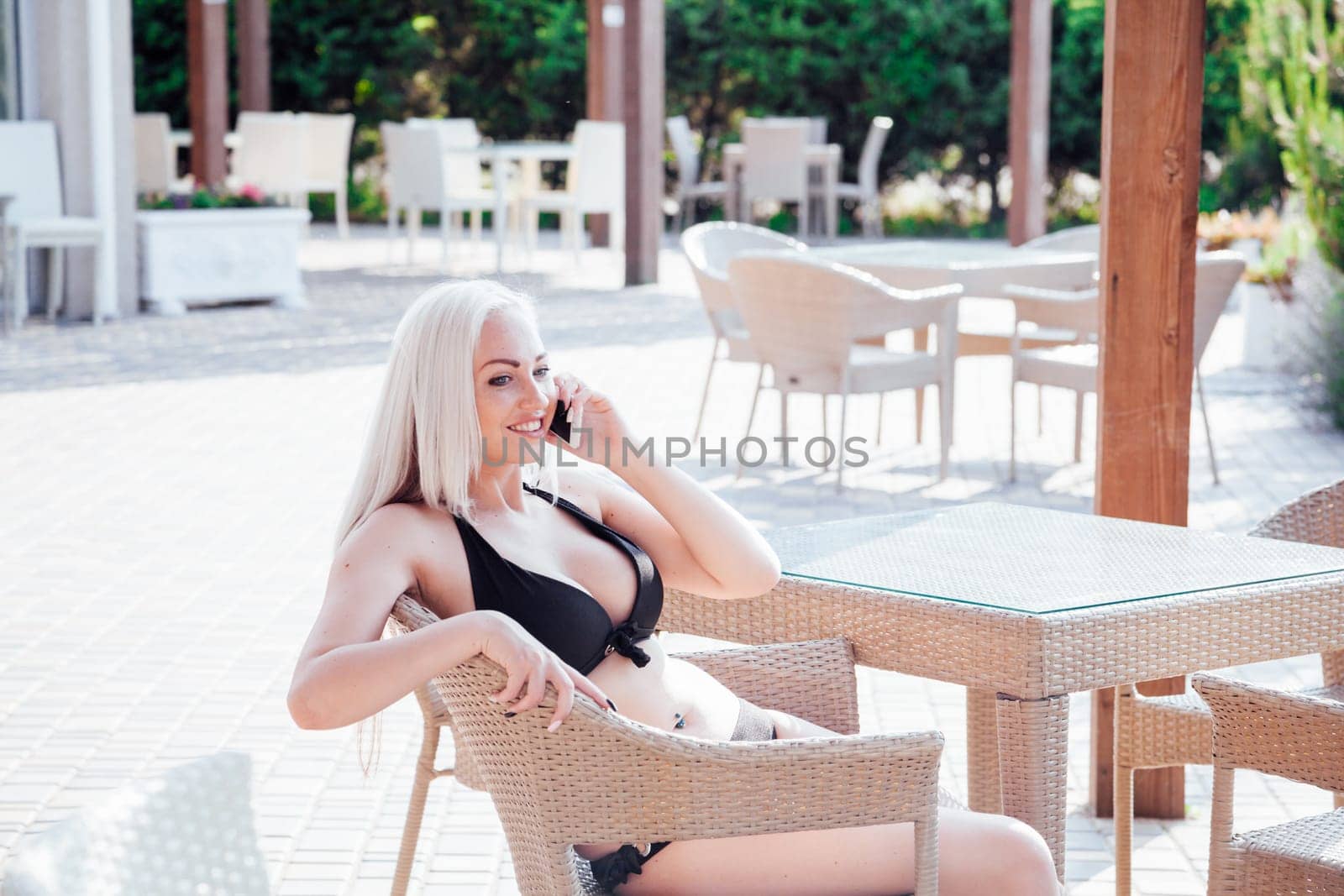 girl at the beach restaurant talking on the phone 1