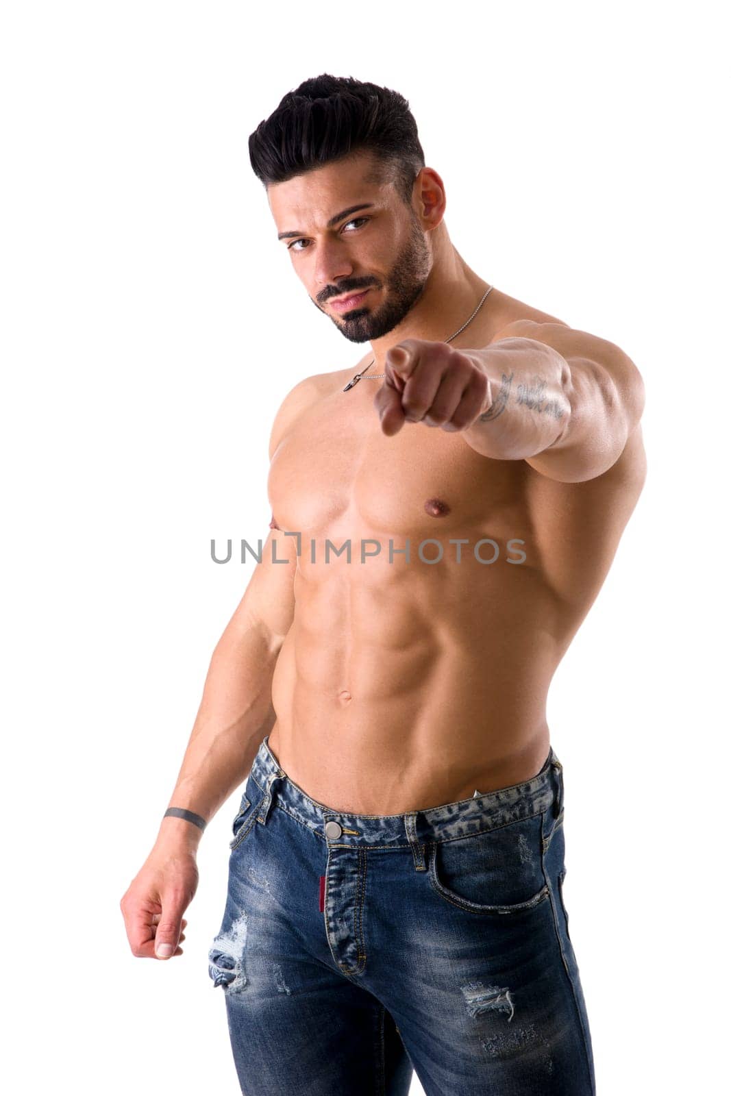 A shirtless man pointing at the camera, isolated on white in studio shot