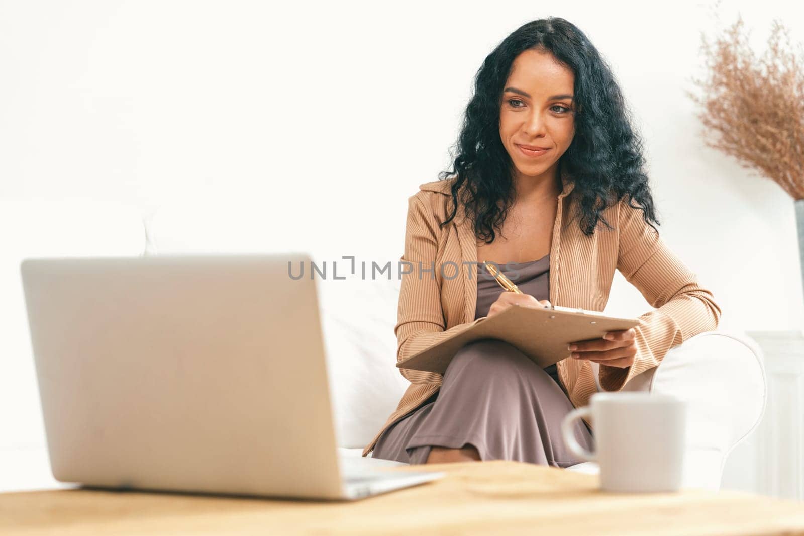 African-American woman using laptop computer for crucial work on internet. Secretary or online content writing working at home.
