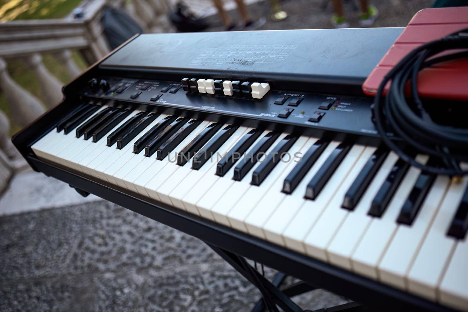 Detailed view of a keyboard, elegantly poised and ready for an exciting live concert.