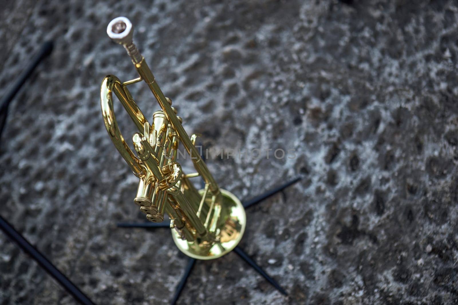 A detailed view of a trumpet set up and waiting, poised for a live concert performance.