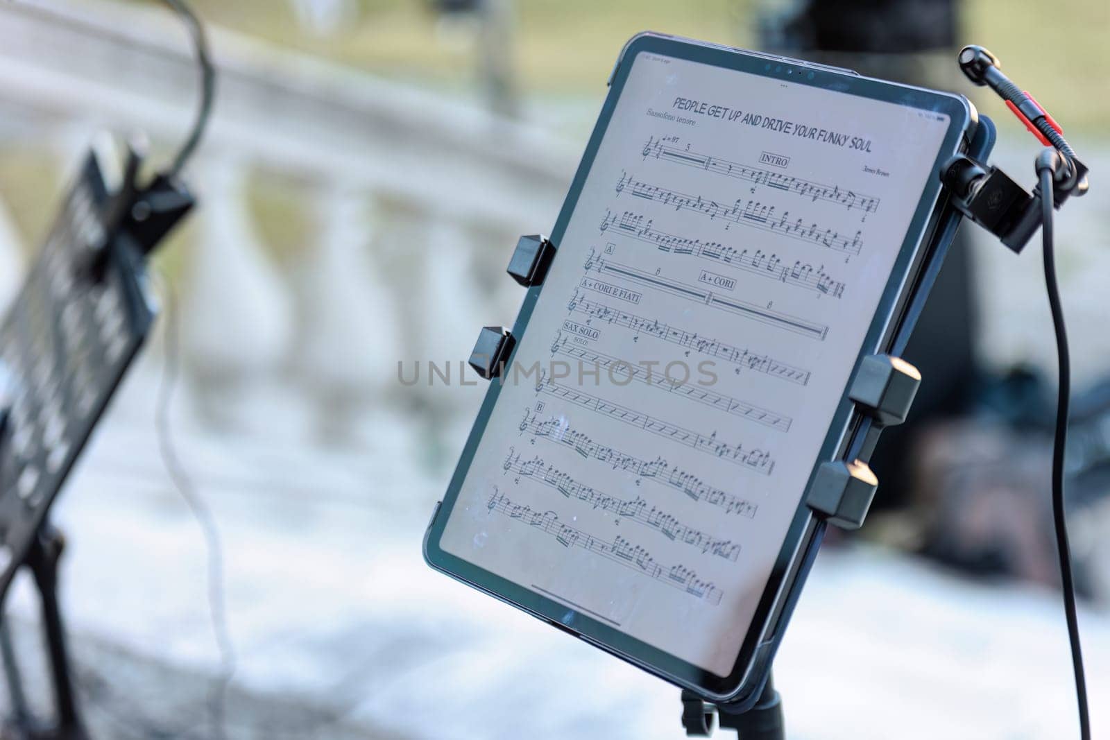 A tablet displaying a musical score, ready for a live concert performance.