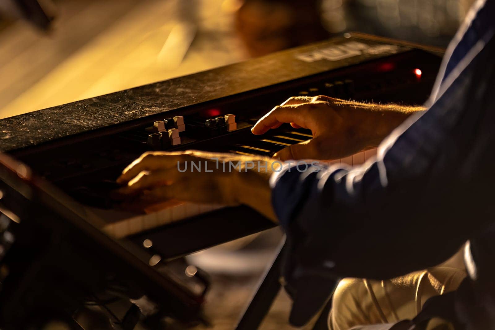 Close-up of a pianist's hands playing passionately in a foggy and atmospheric night concert.