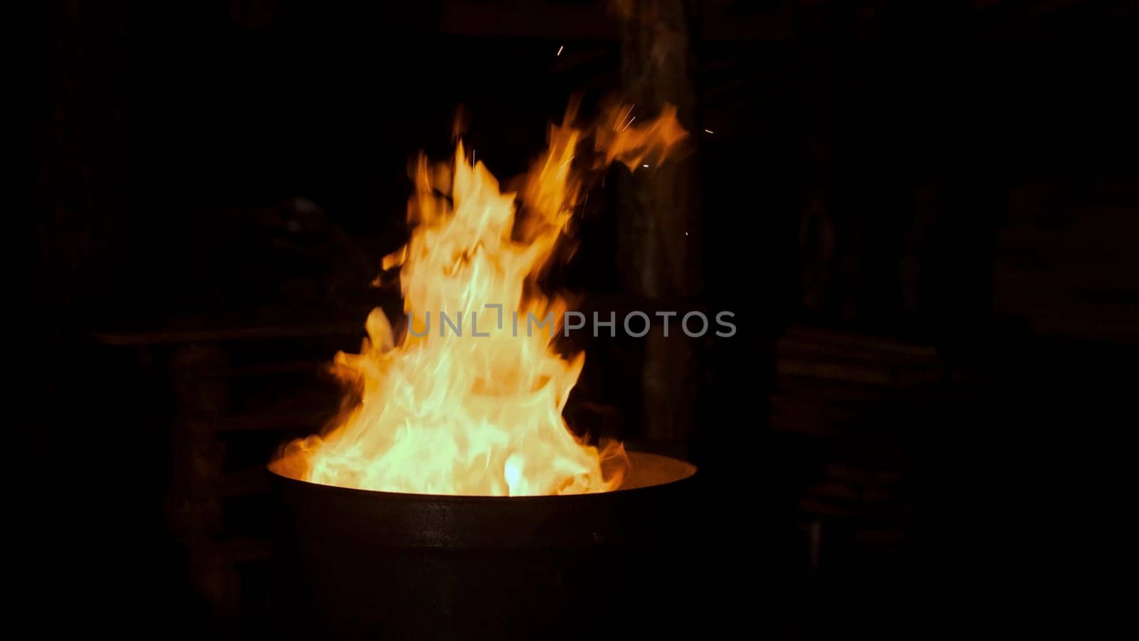 Burning flame at the metal barrel. Clip. Close up of burning fire flame, concept of homeless life