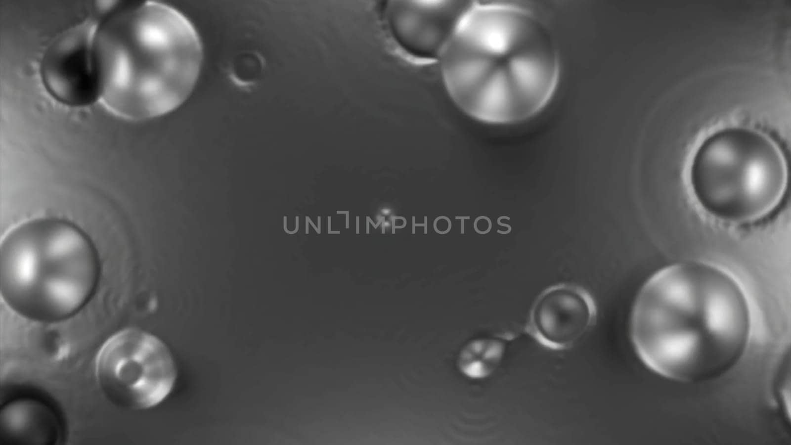 Boiling unknown liquid substance. Design. Round spherical bubbles appear on calm surface