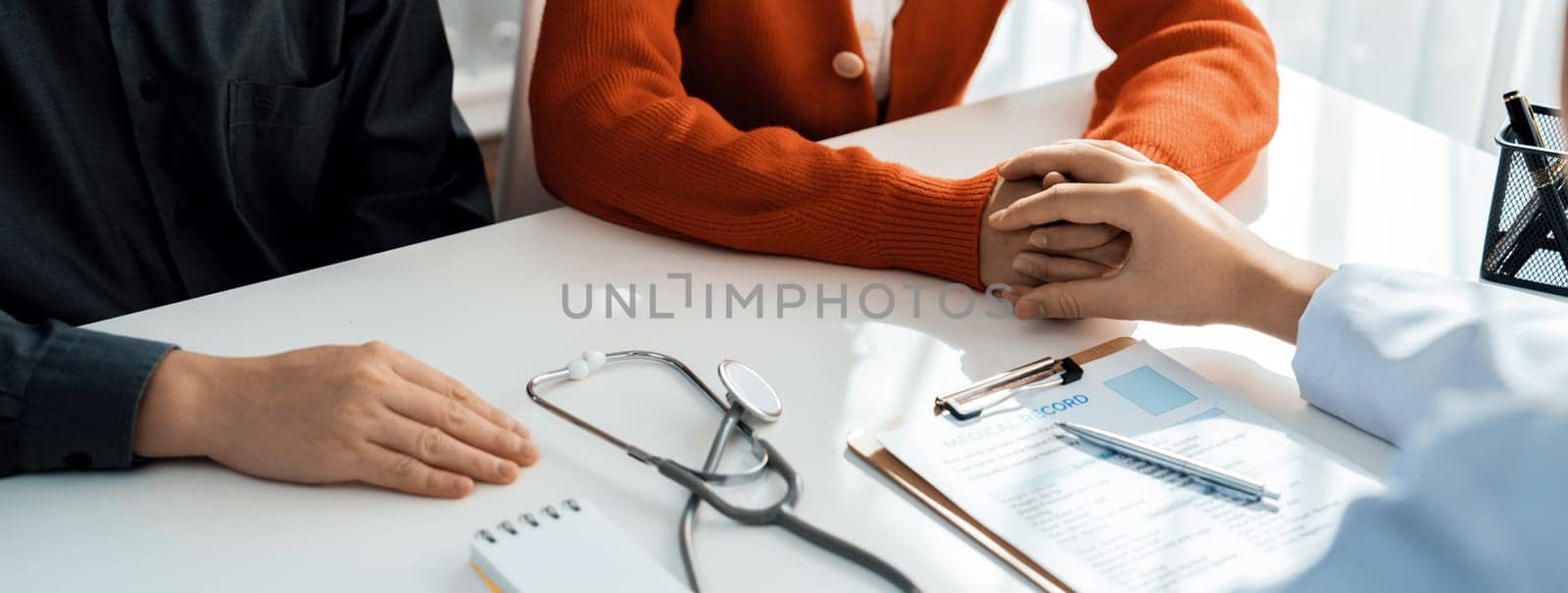 Couple attend fertility or medical consultation with gynecologist at hospital as family planning care for pregnancy while doctor and husband consoling young wife through appointment. Panorama Rigid