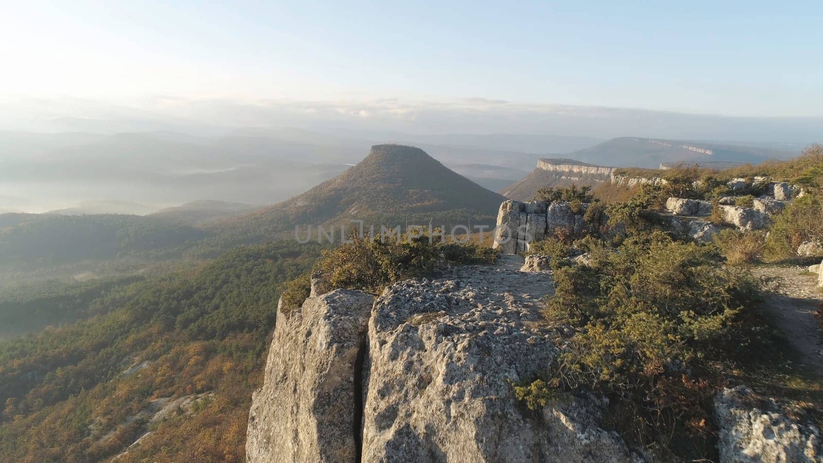 View from the cliff on a mountain, mountain, above the clouds. Autumn mountain landscape