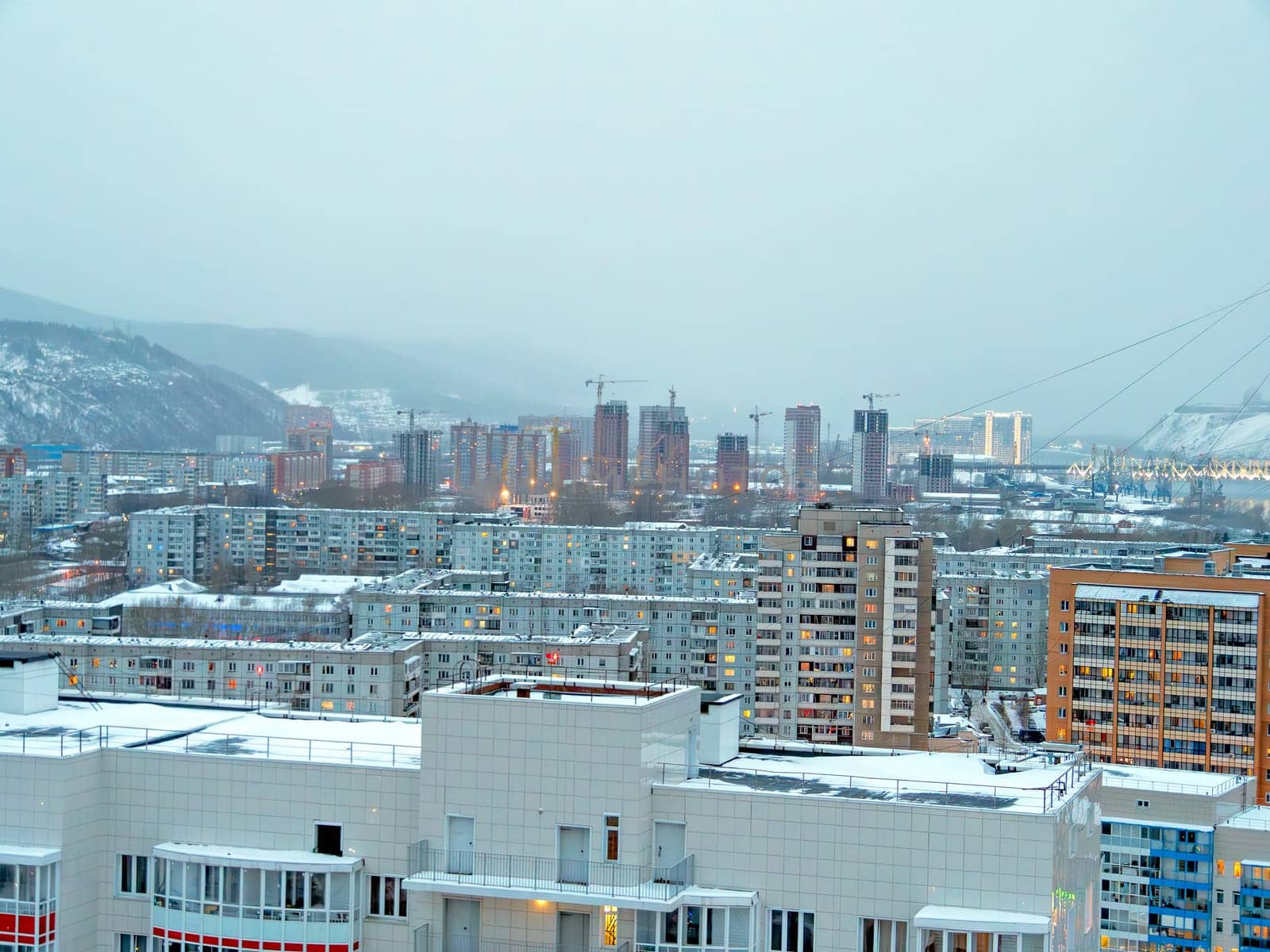 Cityscape on foggy winter evening. Residential dstrict on winter season.