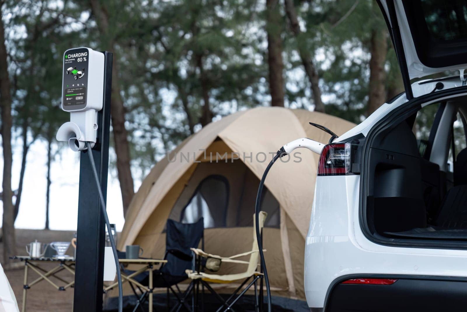 Electric car recharging battery at outdoor EV charging station at natural vacation campsite, alternative and sustainable energy technology eco-friendly car with holiday and travel concept. Perpetual